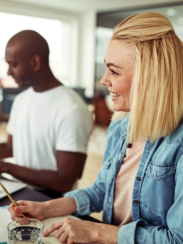 young-businesswoman-smiling-during-a-meeting-in-RM5QXDU.jpg